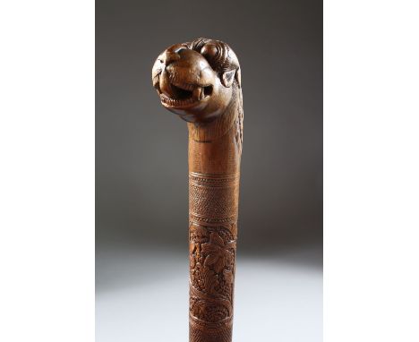 A 19TH CENTURY INDIAN CARVED SANDAL WOOD MAYSORE WALKING STICK, 87cm.