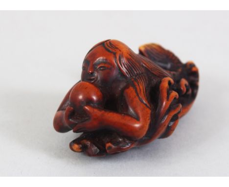 A JAPANESE EDO / MEIJI PERIOD CARVED WOODEN NETSUKE OF NINGYO, the mermaid in a led position upon waves holding a pearl, the 