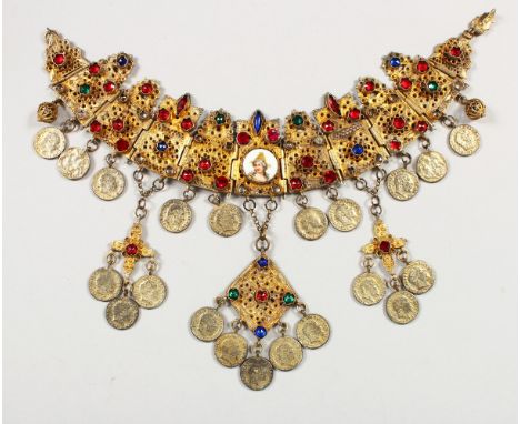 A GOOD INDIAN GILT METAL NECKLACE, mounted with semi precious stones, coins and a small circular porcelain portrait plaque, 3