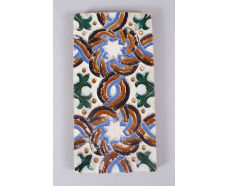 A GOOD 17TH CENTURY HISPANO MORESQUE TILE, with decoration using biscuit, blues and green, 27.5cm x 14.5cm high.