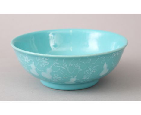 A LOVELY CHINESE PEACOCK BLUE GROUND BOWL, the body with carved decoration of double gourds and foliage, the base bearing a f