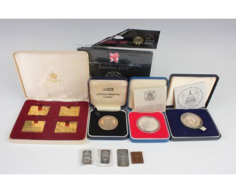 A collection of various commemorative coins, ingots and first day coin covers, including a Hallmark Replicas silver gilt four