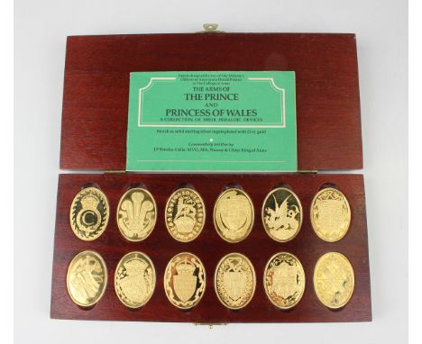 A set of twelve Elizabeth II silver gilt oval ingots commemorating the Arms of the Prince and Princess of Wales, each detaile