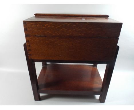 An Oak Sewing Box Table with Hinged Lid and Stretcher Shelf.
