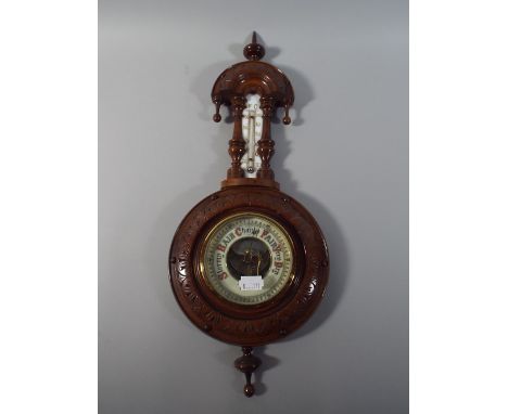 A Late Victorian Carved Mahogany Wall Barometer with Enamelled Dial and Temperature Scale.