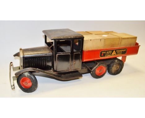 A Lines Bros tinplate friction powered `Tri-ang Transport` flat bed truck having black cab and chassis, red tipping flat bed,