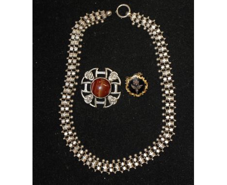 A Scottish Silver Brooch, Set With A Banded Agate Stone, A Black Enamel Memorial Brooch, and An Indian Silver Necklace 