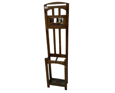 Edwardian oak hall stand, raised mirror back with flanking coat hooks, over umbrella or stick stand with drip trays to baseDi