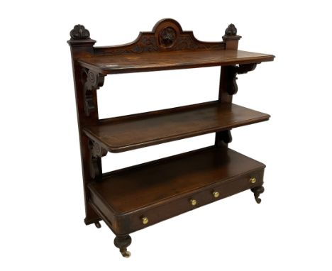 Victorian mahogany three-tier buffet, raised back with scrolling caved foliate decoration and central applied floral motif, s