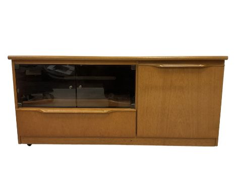 Teak media cabinet, glazed doors enclosing sliding tray over fall-front, fitted with cupboard to the side with revolving CD c