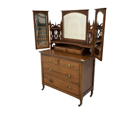 Late Victorian walnut dressing chest, triple mirror back with hinged bevelled plates, the shelves with pierced lyre supports,