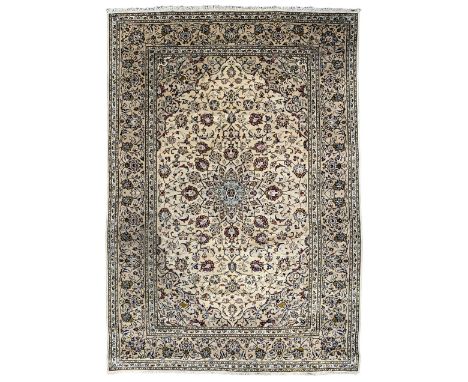 Persian Kashan ivory ground rug, the central star medallion with a surrounding ring of palmette motifs, extending into the fi