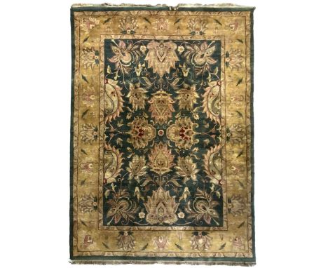 Indo-Persian emerald ground thick pile carpet, the field decorated with large lotus and Boteh motifs connected by scrolling f