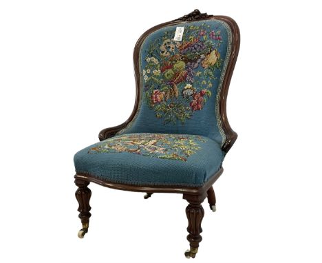 Victorian mahogany framed nursing chair, applied rose carved cresting rail, back and sprung seat upholstered in floral tapest