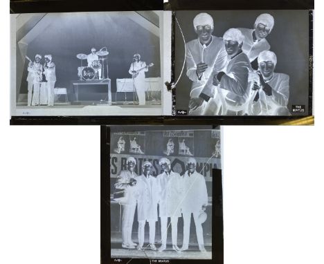 DEZO HOFFMAN GLASS NEGATIVES. Three original glass photo negatives, one depicting The Beatles onstage in France, two depictin