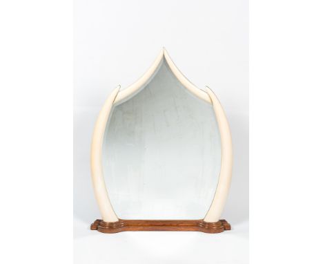 Full title: A large mirror set in faux ivory tusks, 20th C.Description:128 x 97 cmAbout this sale: Paul De Grande is one of t