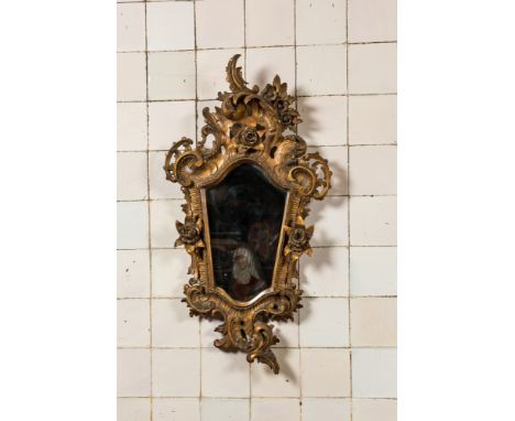 Full title: A French finely carved gilt wooden Louis XV-style rocaille mirror with roses, 18/19th C.Description:83 x 44 cmAbo