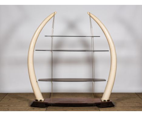 Full title: A large Žtagre with glass shelves set in faux ivory tusks, 20th C.Description:H 185 x L 168 x D 40 cmAbout this s