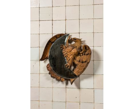Full title: A crescent moon-shaped mirror in a basswooden 'eagle' frame in the style of Viardot, 19/20th C.Description:47 x 4