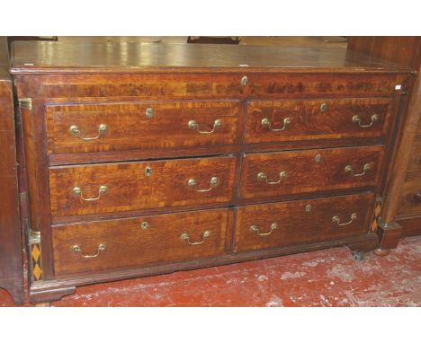 A George III oak and crossbanded mule chest, with false and short drawers flanked by turned columns, on ogee bracket feet, 97