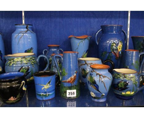 Torquay Long Park pottery to include a pair of vases, jugs, candlestick and bowls, each decorated with birds (20)
