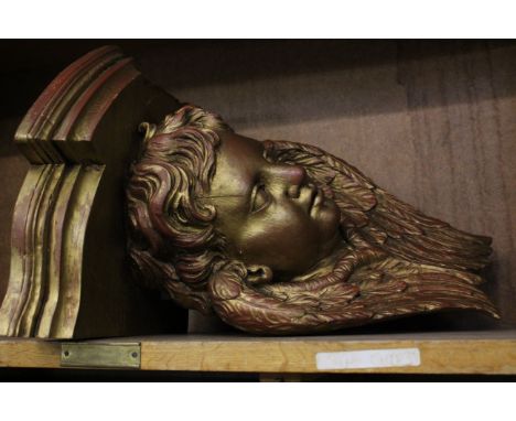 A giltwood corner bracket of a cherub 45cm high 