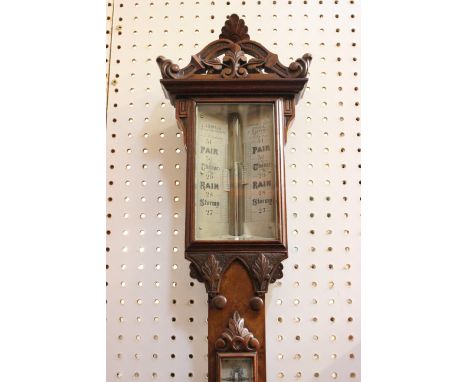 A Victorian walnut mercury stick barometer, J.Sewill, circa 1840, the pierced architectural pediment above rectangular bevel 