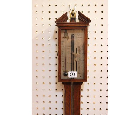 A late George III inlaid mahogany stick barometer, Tarone, circa 1800, with architectural pediment and brass urn final above 