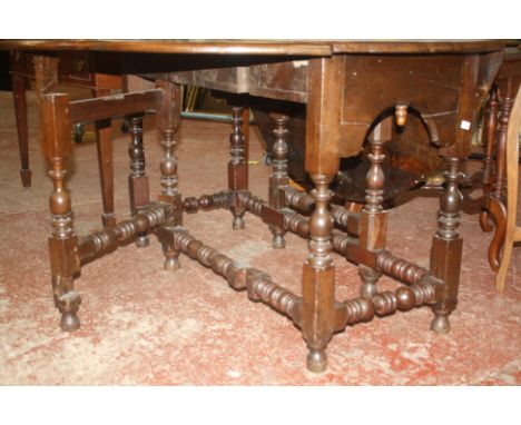 A 17th Century and later oak gateleg table with ring turned and baluster legs joined by stretchers 143cm extended 