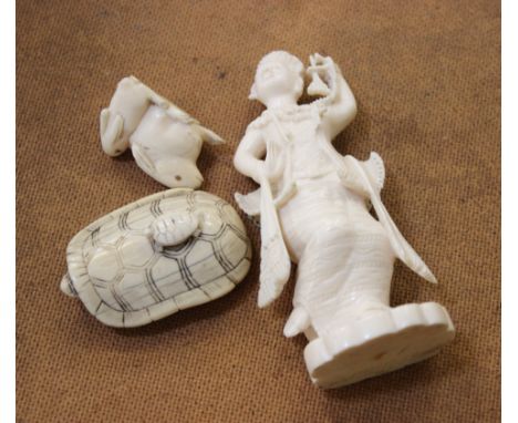 A Meji period Japanese ivory netsuke of a turtle with a baby turtle on back, a pair of rabbit netsuke and a carved figure of 