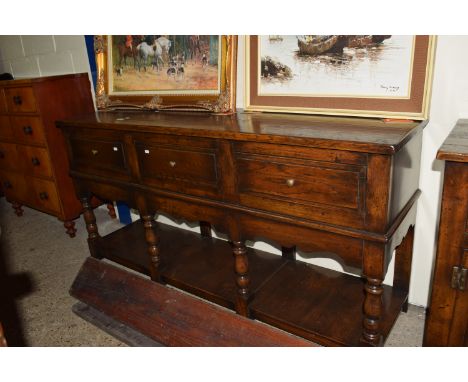 LOW DRESSER RAISED ABOVE A LOW SHELF ON TURNED LEGS TO A SHAPED FRIEZE BENEATH, THREE DEEP DRAWERS, APPROX 168 X 45CM