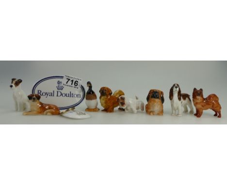A collection of Royal Doulton K series dog figures to include Pekingese, King Charles Spaniel, Seated Sealyham terrier, Beggi