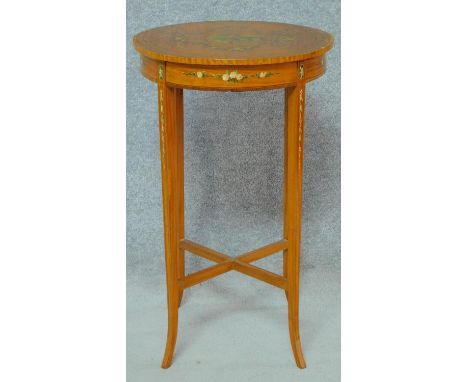 A late 19th century satinwood quarter veneered lamp table with rosewood crossbanding and Angelica Kauffman style painted cher