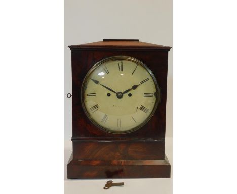 A Regency mahogany cased bracket clock with white painted dial and Roman numerals on plinth base. H.40 W.29 D.16cm 