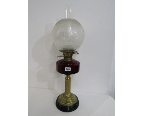 ANTIQUE OIL LAMP, brass column base cut ruby glass reservoir oil lamp with spherical glass shade, 60cm height 