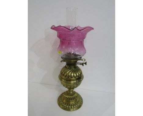 ANTIQUE OIL LAMP, brass fluted circular base oil lamp with cranberry crinoline glass shade, 47cm height 
