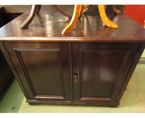 A circa 1920 oak two door cupboard on bracket feet, 70cm x 87cm x 54cm