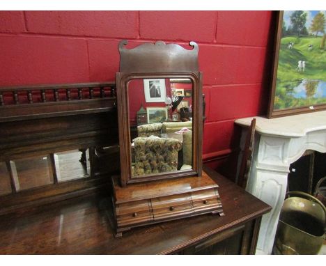 A George II style mahogany toilet mirror the fretwork decorative top tilting mirror over a waterfall stepped base of three dr