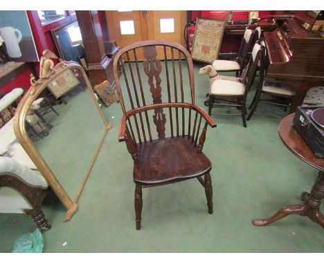 Stamped "H.S." circa 1860 an elm and oak stick back Windsor elbow chair the hoop back with fret central splat over ring turne