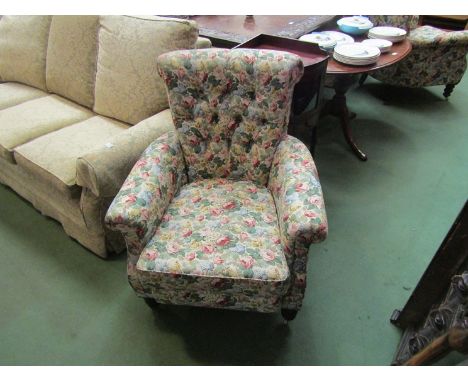 A pair of Edwardian Howard/Shoolbred style country house armchairs with sprung front edge on ring turned legs and castors