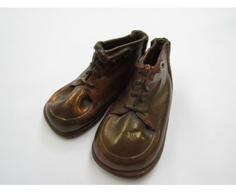 A pair of worked copper vintage style boots, 13cm long, 6cm tall