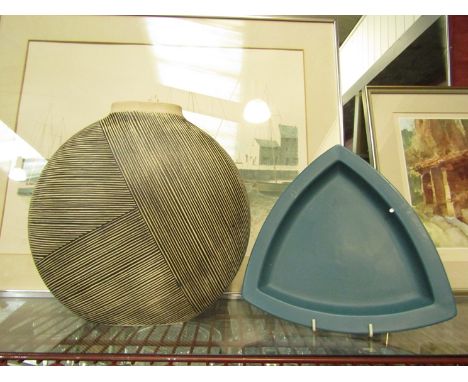 A modern flat design vase with lined design and a ceramic dish