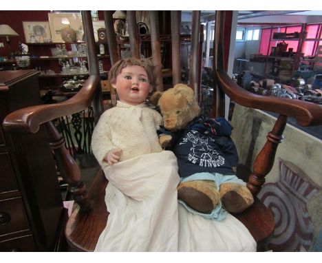 A Germany porcelain faced doll and vintage teddy