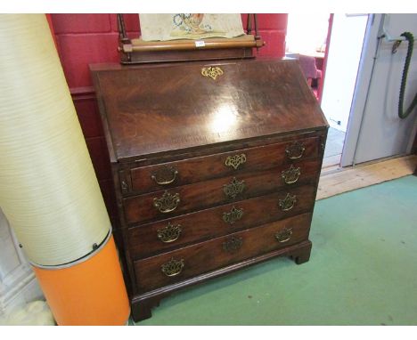 A George III flame mahogany bureau the fully fitted interior over four long drawers and bracket feet (with key)