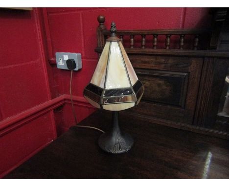 A bronzed Art Deco style lamp base with Tiffany style leaded shade, (slight crack to base)
