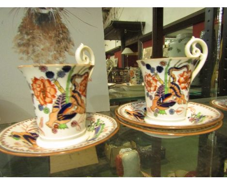 Late 19th Century Coalport coffee cans and saucers with lion design