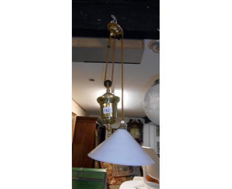 A brass French style rise and fall lamp