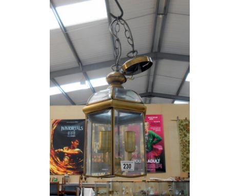 A brass framed lantern with bevelled glass panels