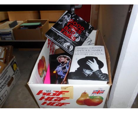A box of books on singers, groups etc including The Rolling Stones, The Clash etc