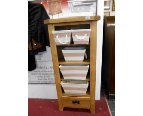 A rustic solid oak shelf unit with fabric baskets